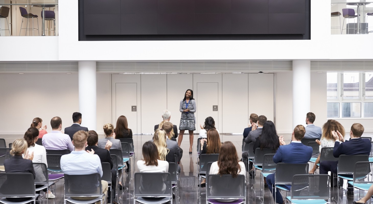 female business leader making presentation in modern office building