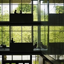 multiple levels in a glass building with executives on various floors