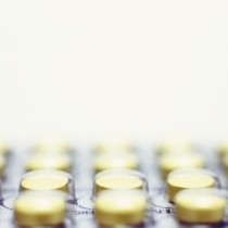 close up of round yellow pills in blister pack