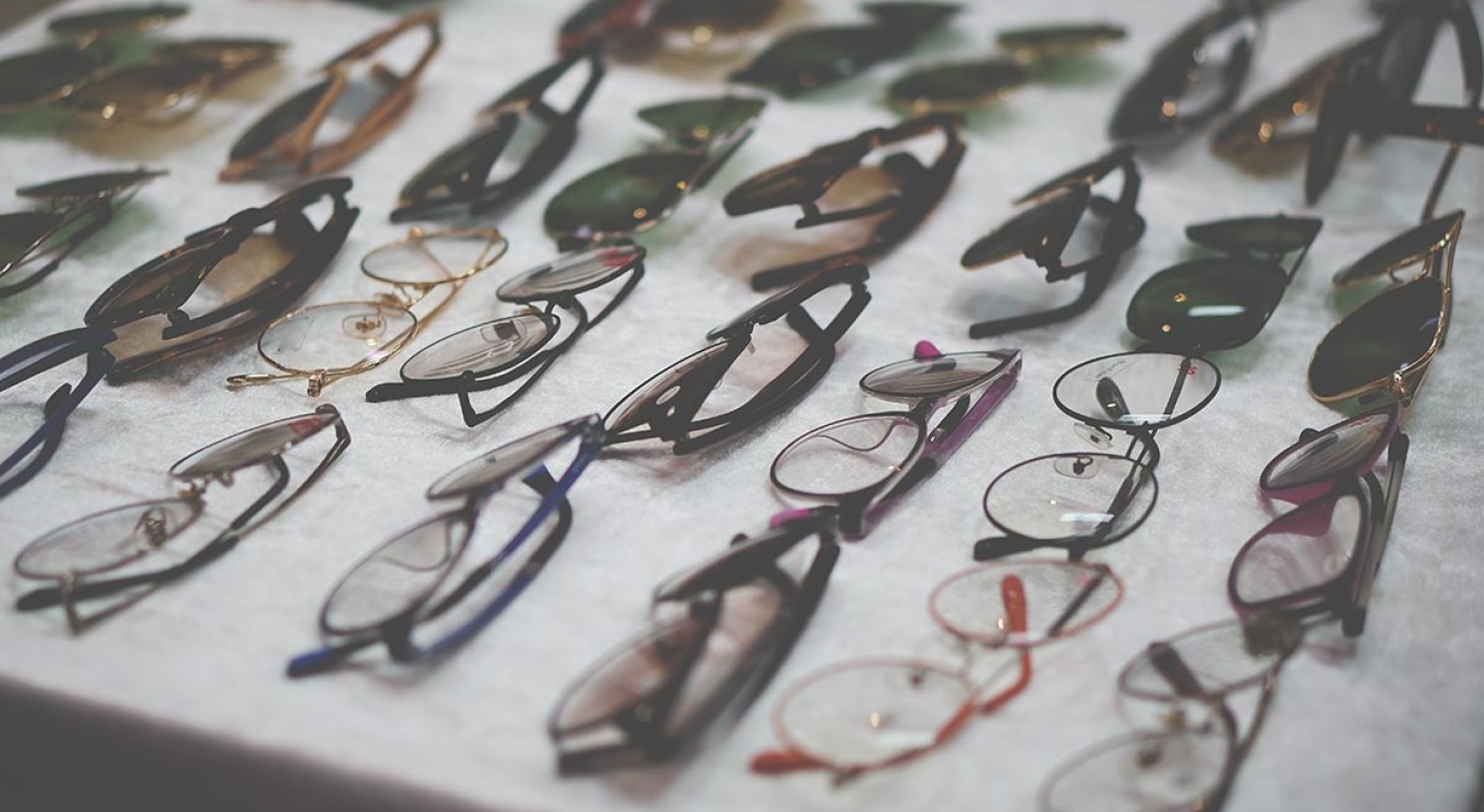 selection of eyeglasses frames on gray table