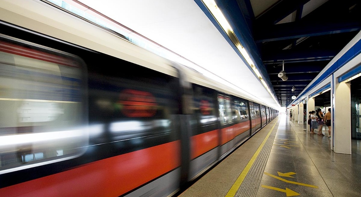 blurred view of speeding red train in station