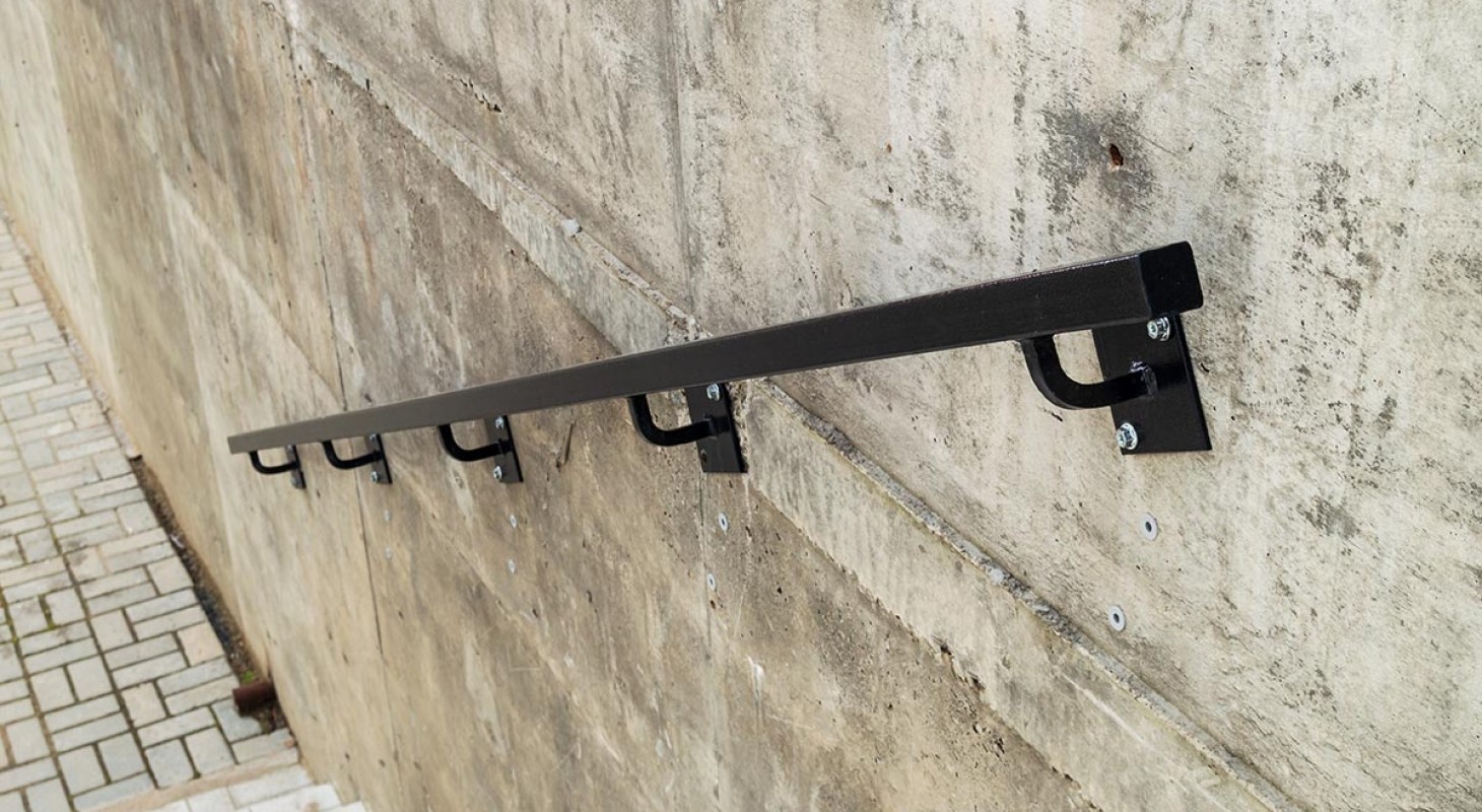 black metal handrail on concrete wall