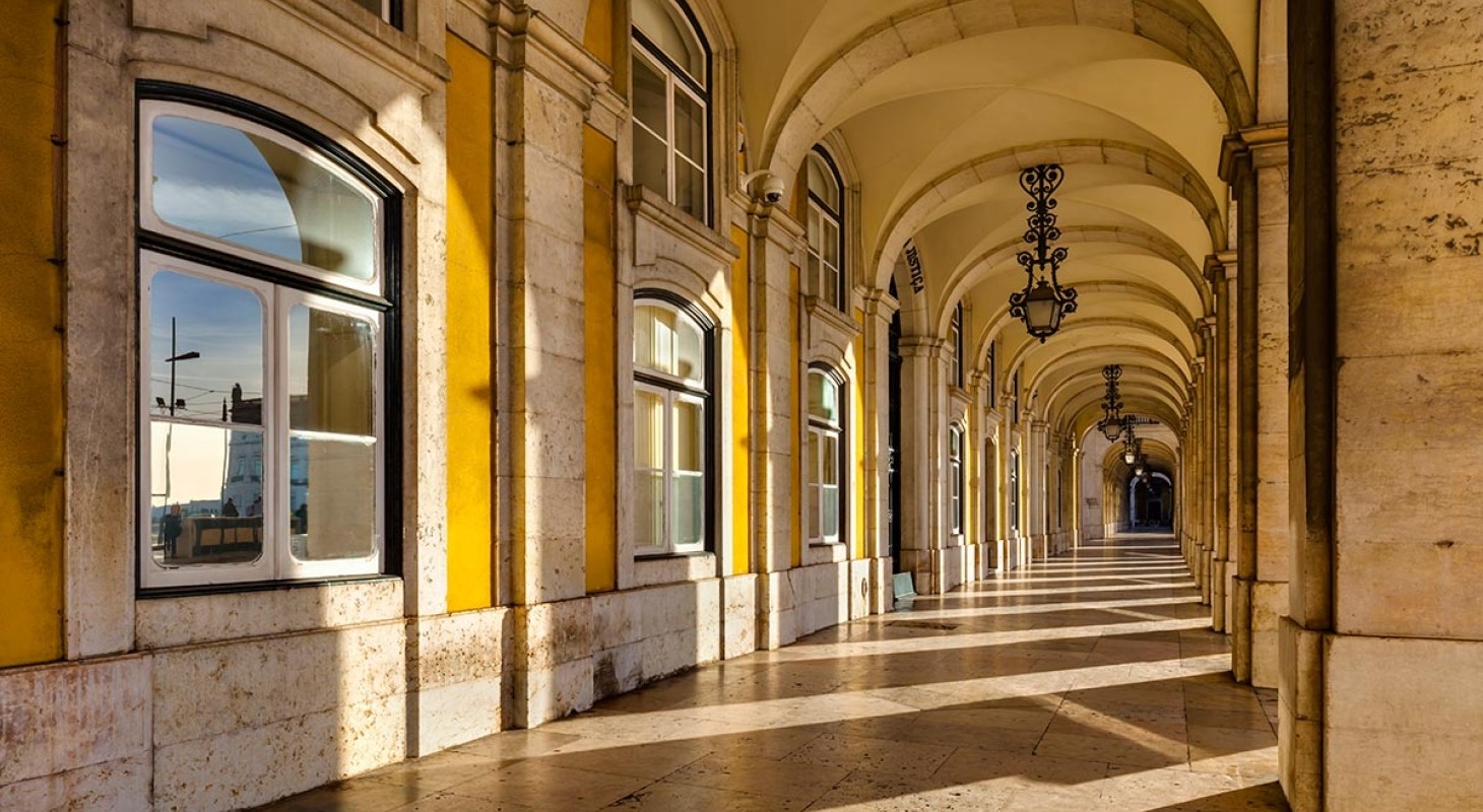 long breezeway of arches in golden light