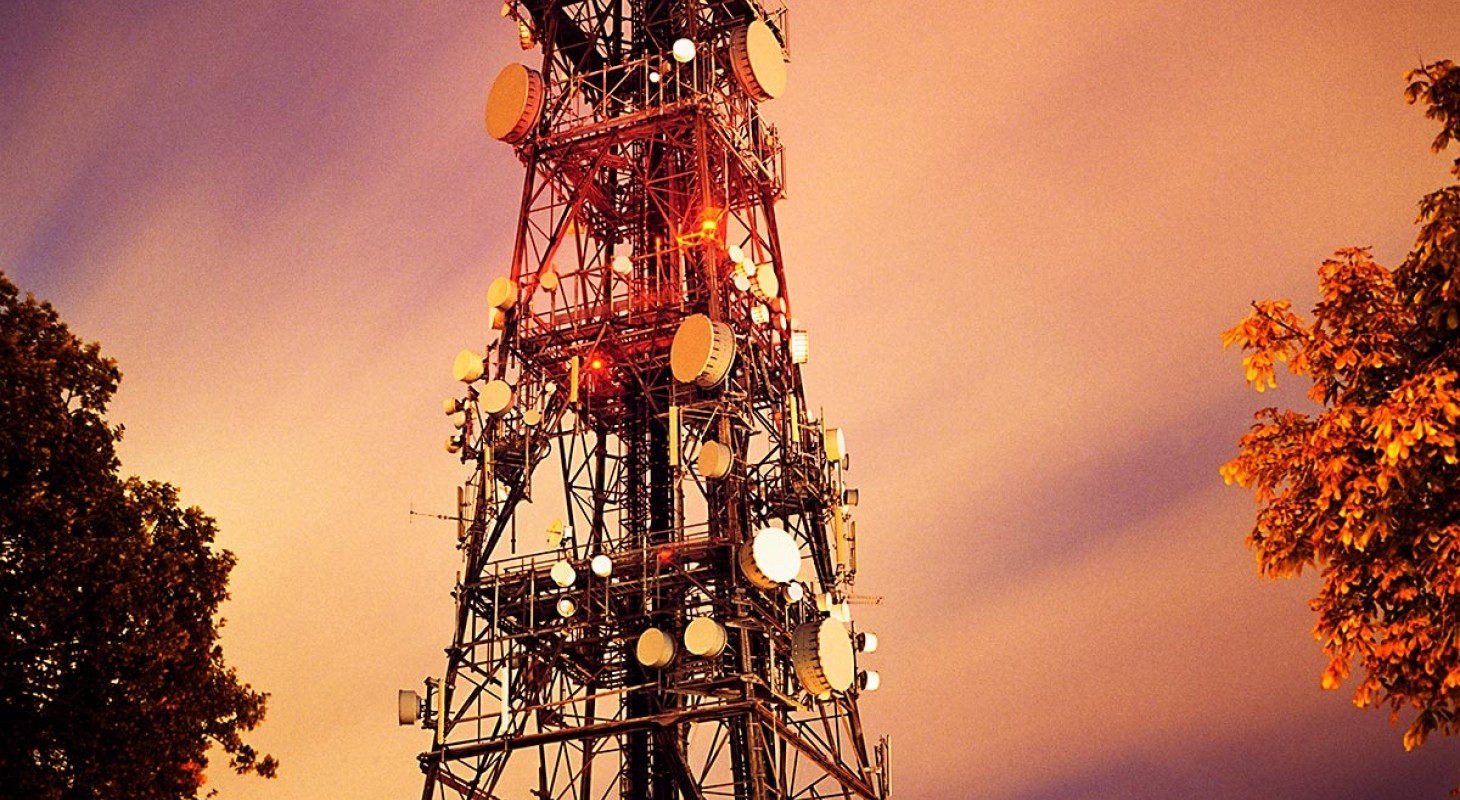 massive radio transmitter tower against sunset