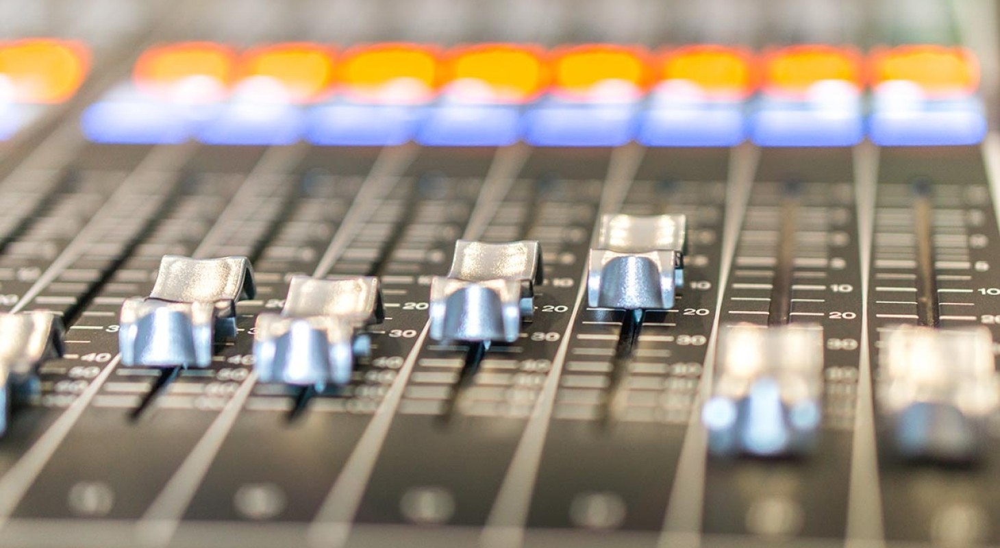 sound mixing board with orange and blue lights