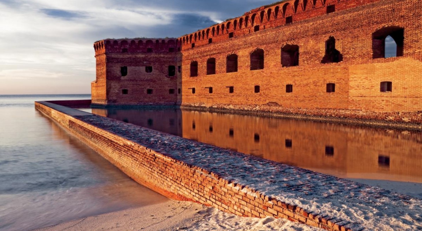 Ocean front fort with brick moat at sunset