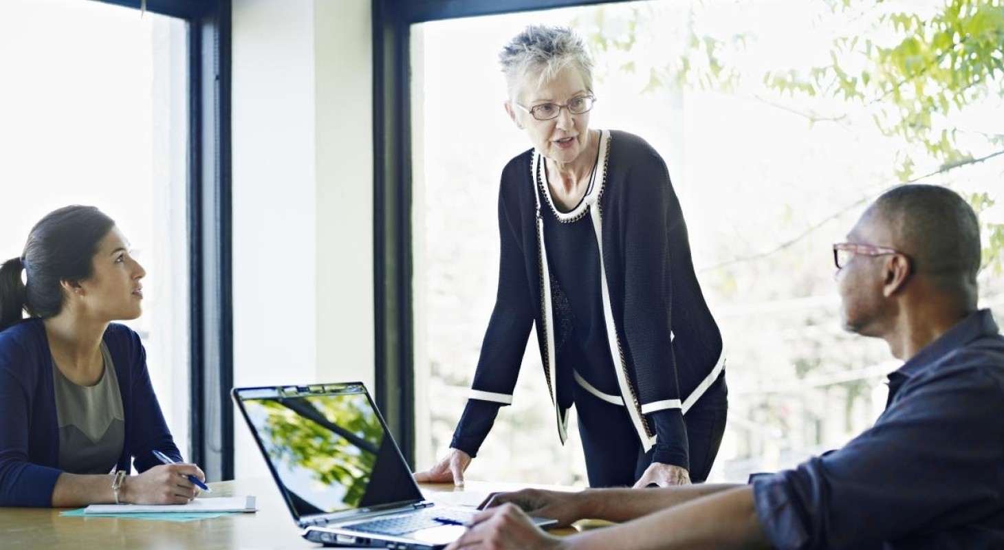 strong female executive talking with two colleagues