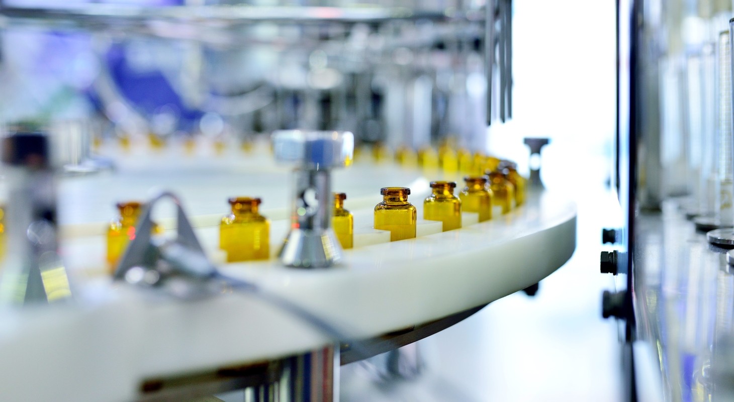 close up of brown glass bottle production line
