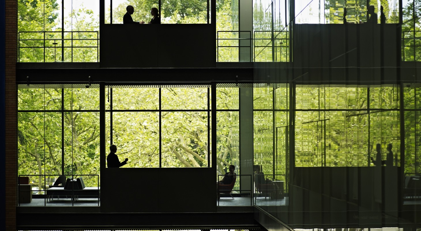 multiple levels in a glass building with executives on various floors