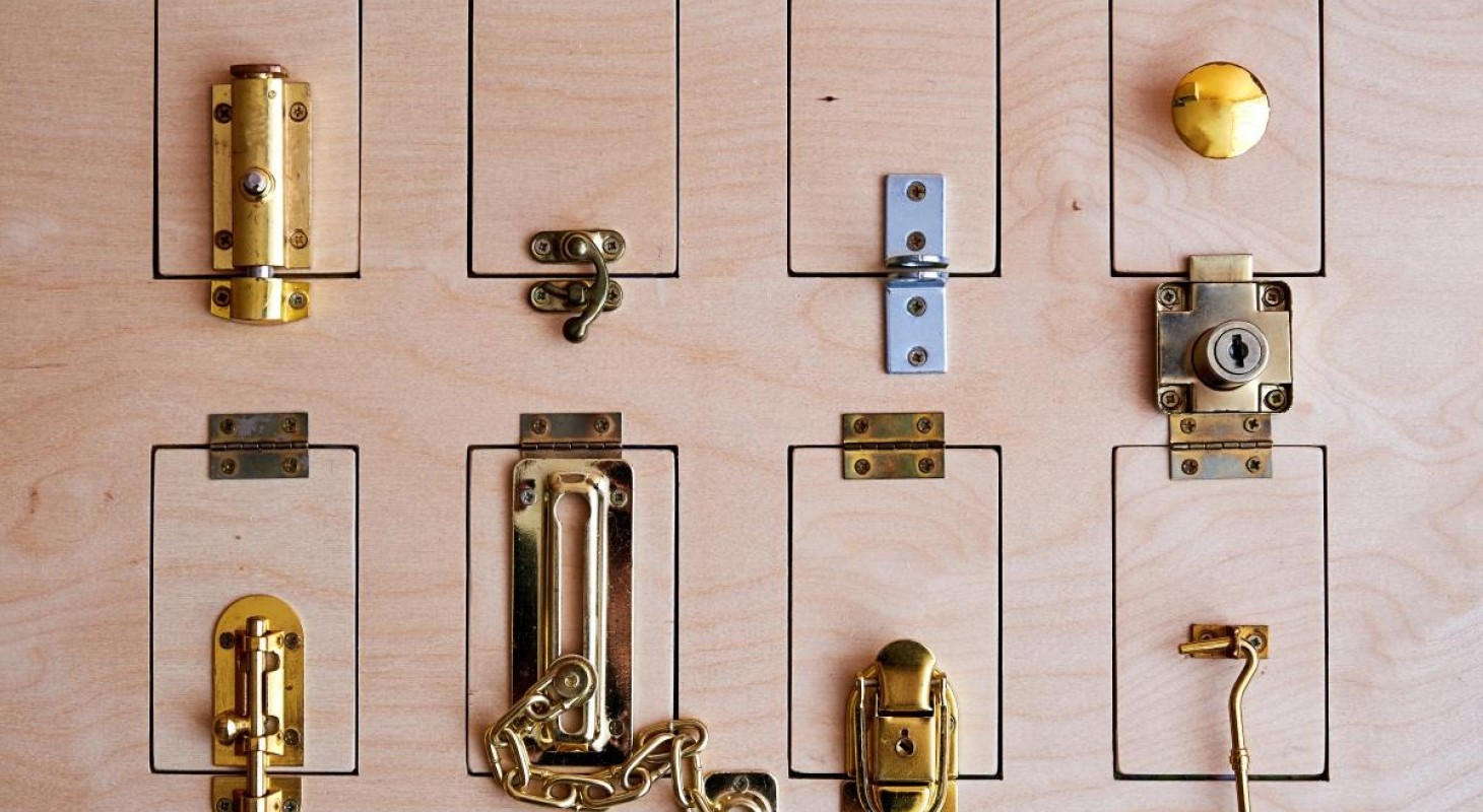 eight different locks on a slab of wood
