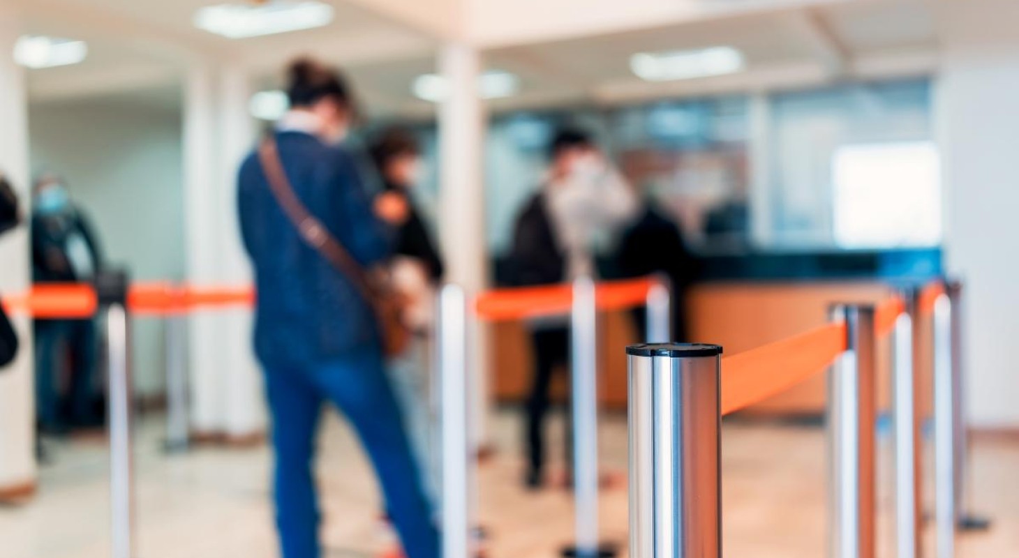 soft focus on people standing in bank teller line