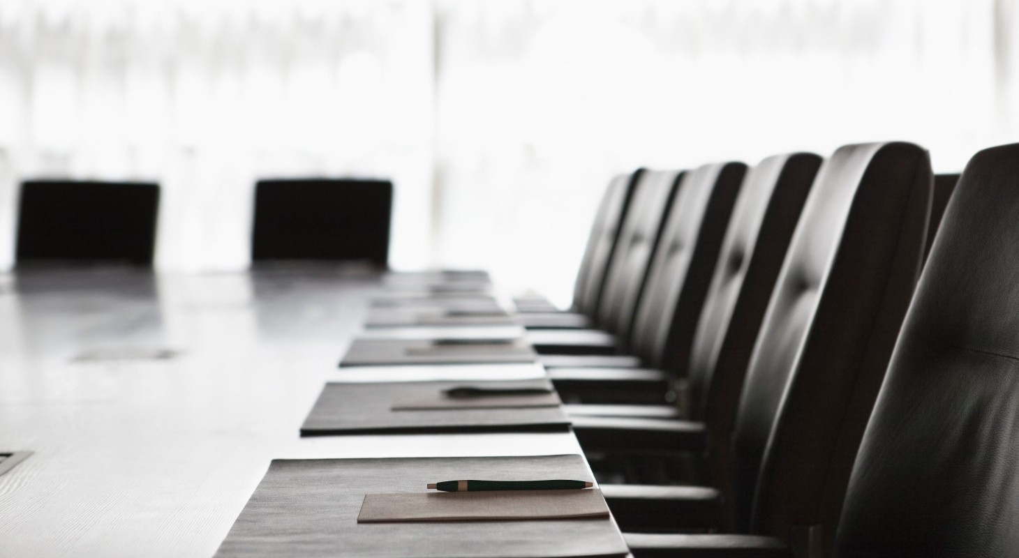 folders and pens on meeting table