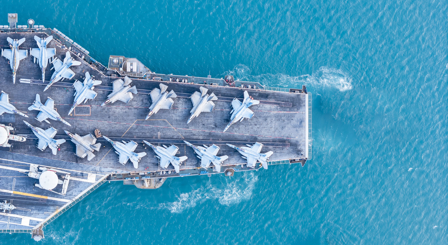 military navy ship carrying fighter jets