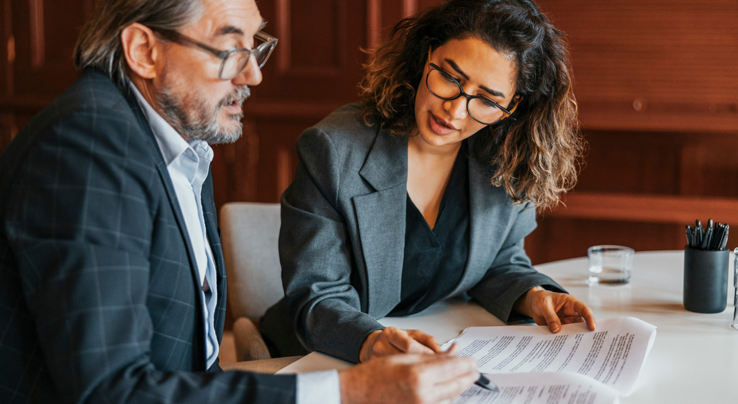 male and female business professionals examing document