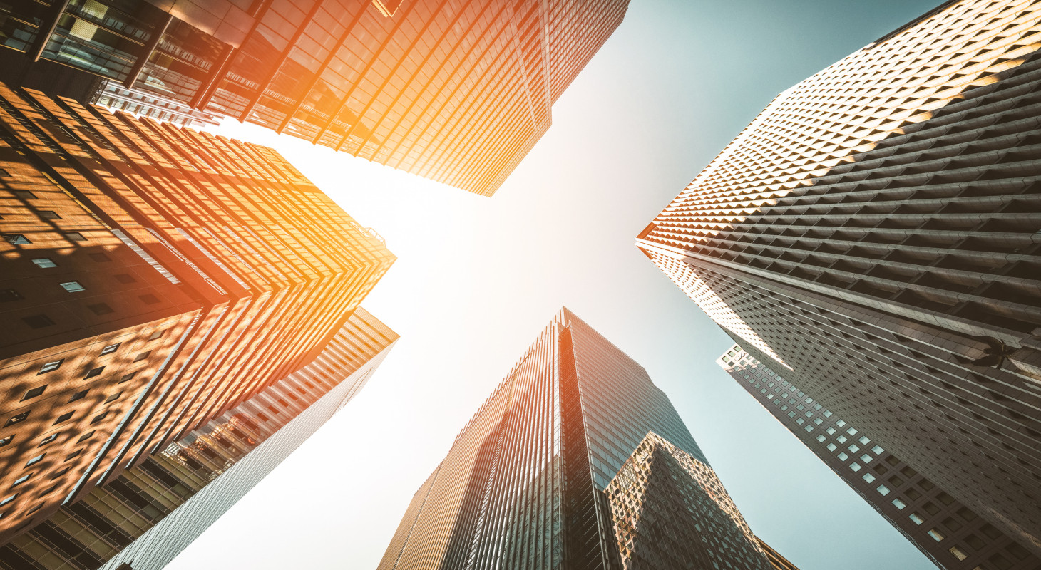 skyscrapers reaching towards sunlit sky
