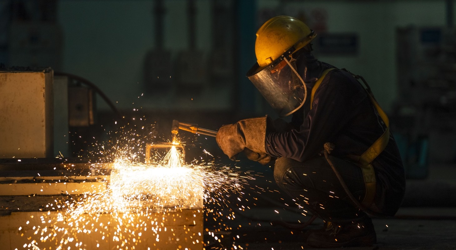 welder welding steel in workshop
