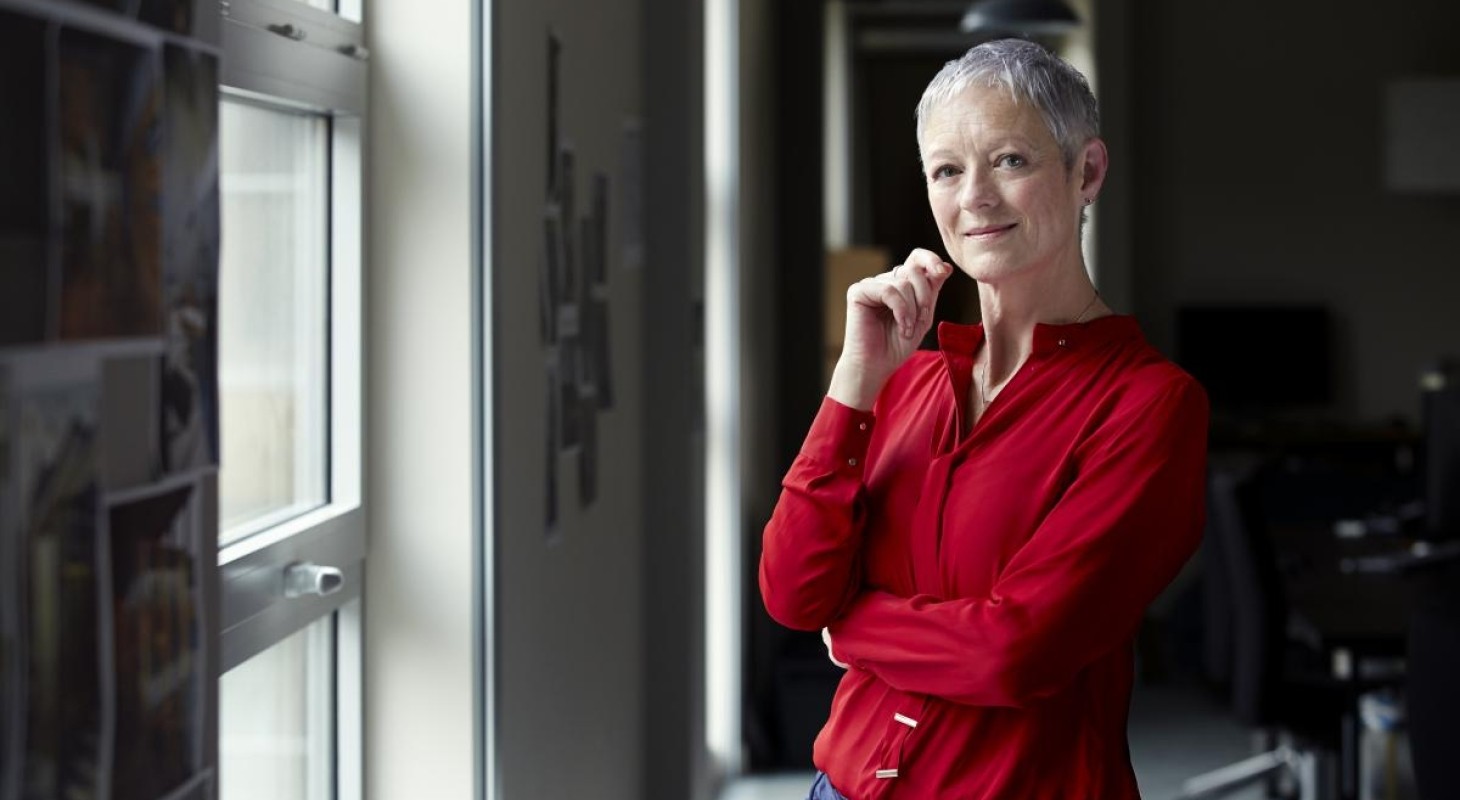 female executive with cropped gray hair in bright red blouse