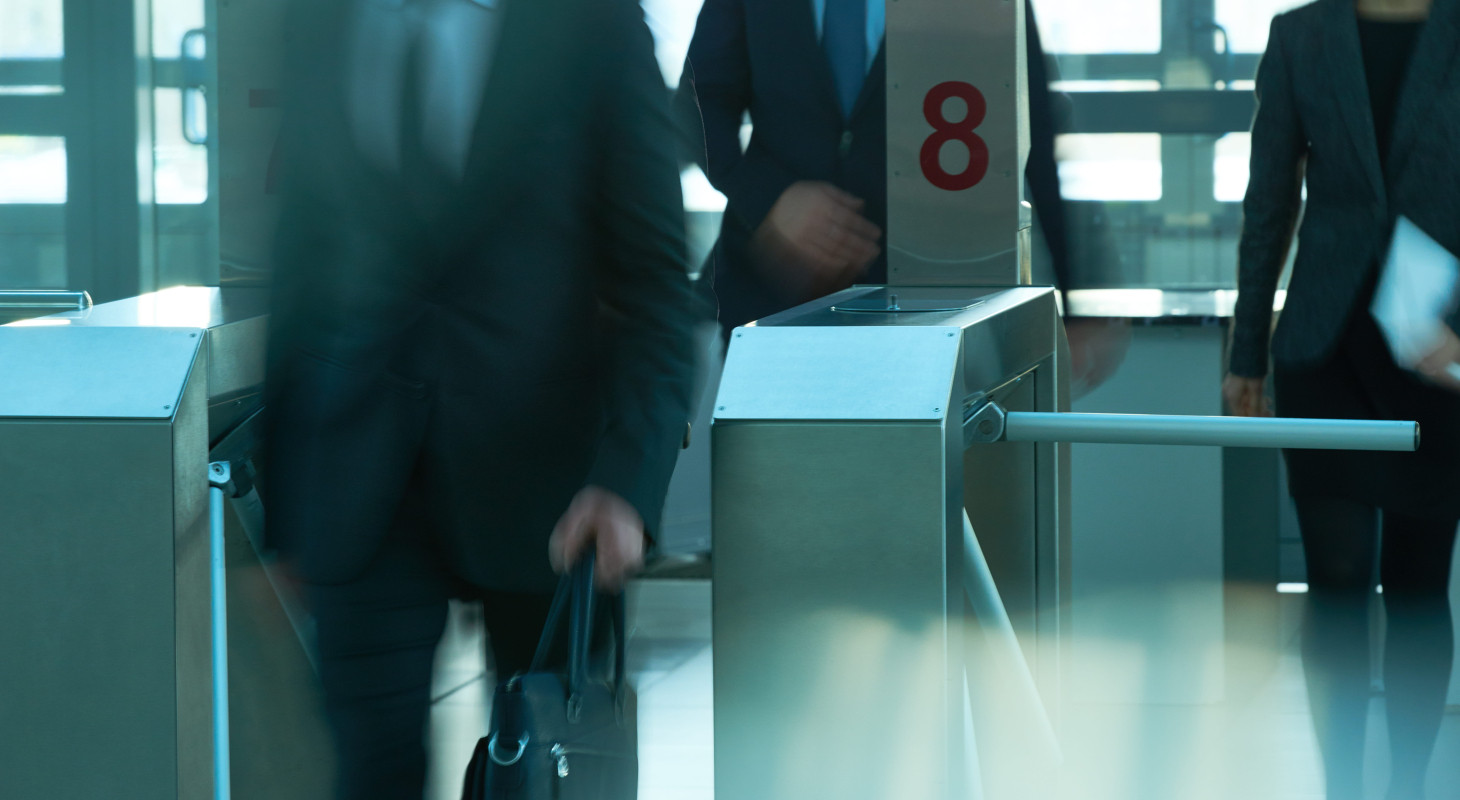 business people coming to work through security