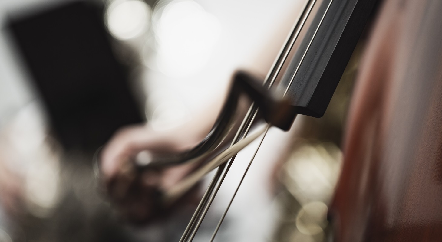 cello and bow in motion and out of focus