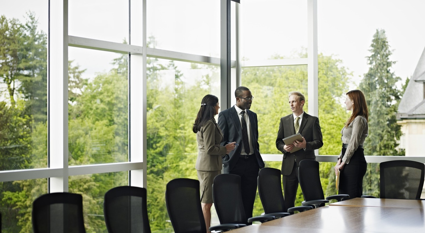 coworkers standing in conference room