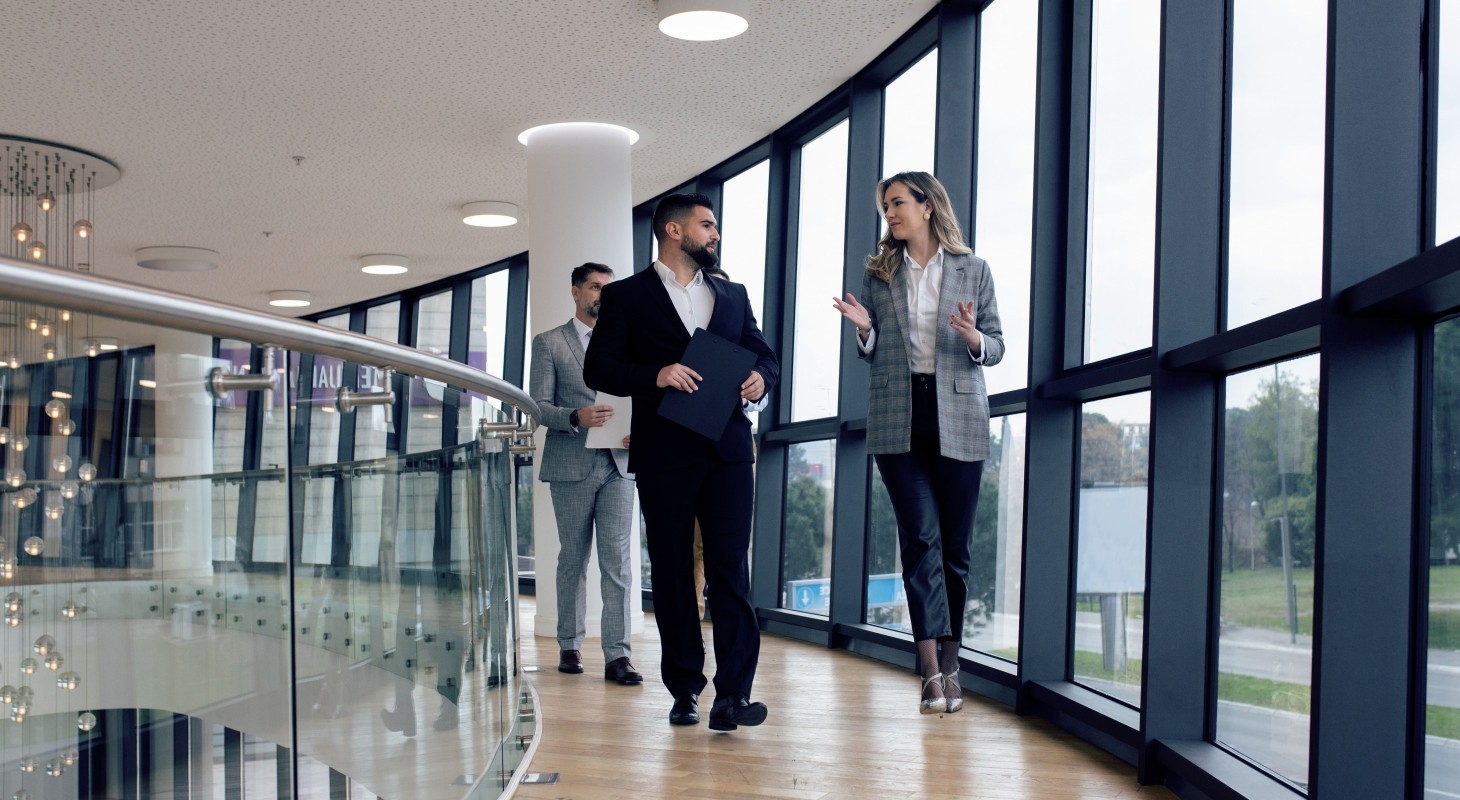 group of corporate business colleagues walking along the corridor