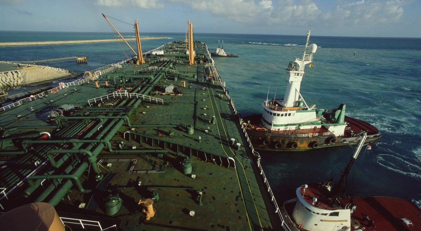 elevated view of oil tanker ship and tugboats