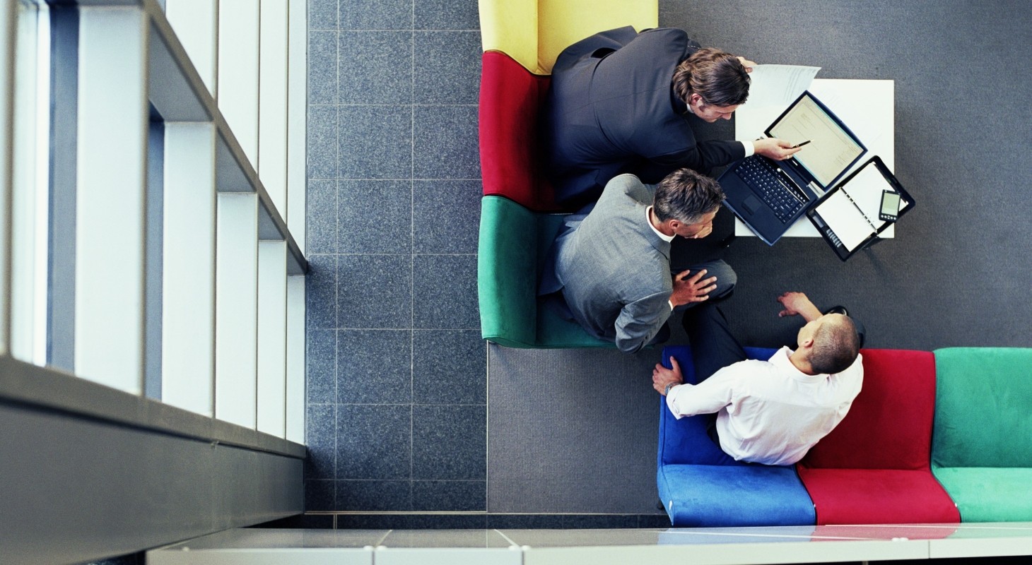 three businessmen in meeting, overhead view