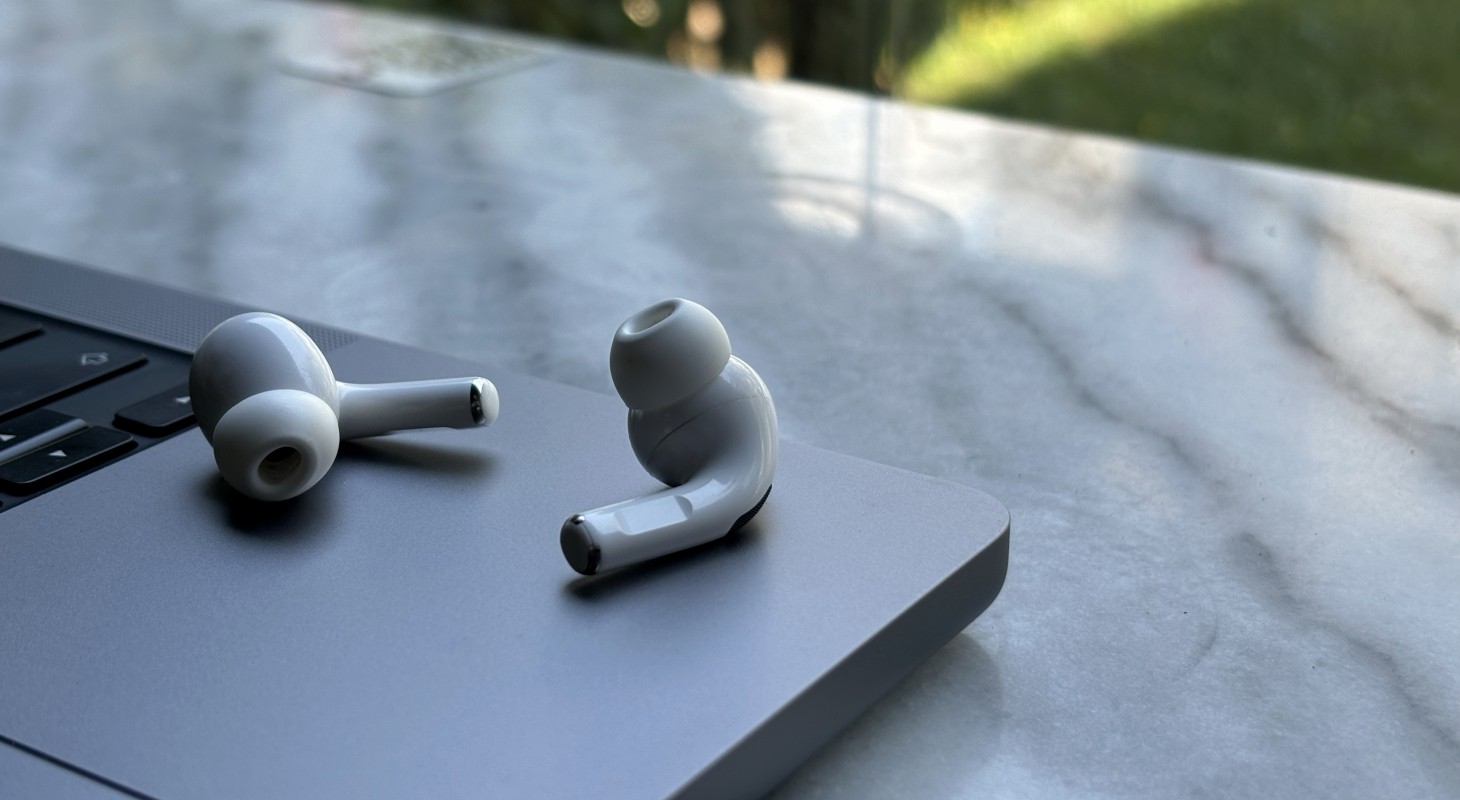 airpods resting on laptop on outside table