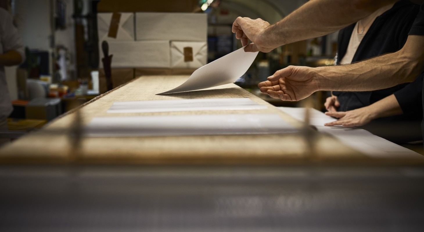 two bookbinders working together in workshop