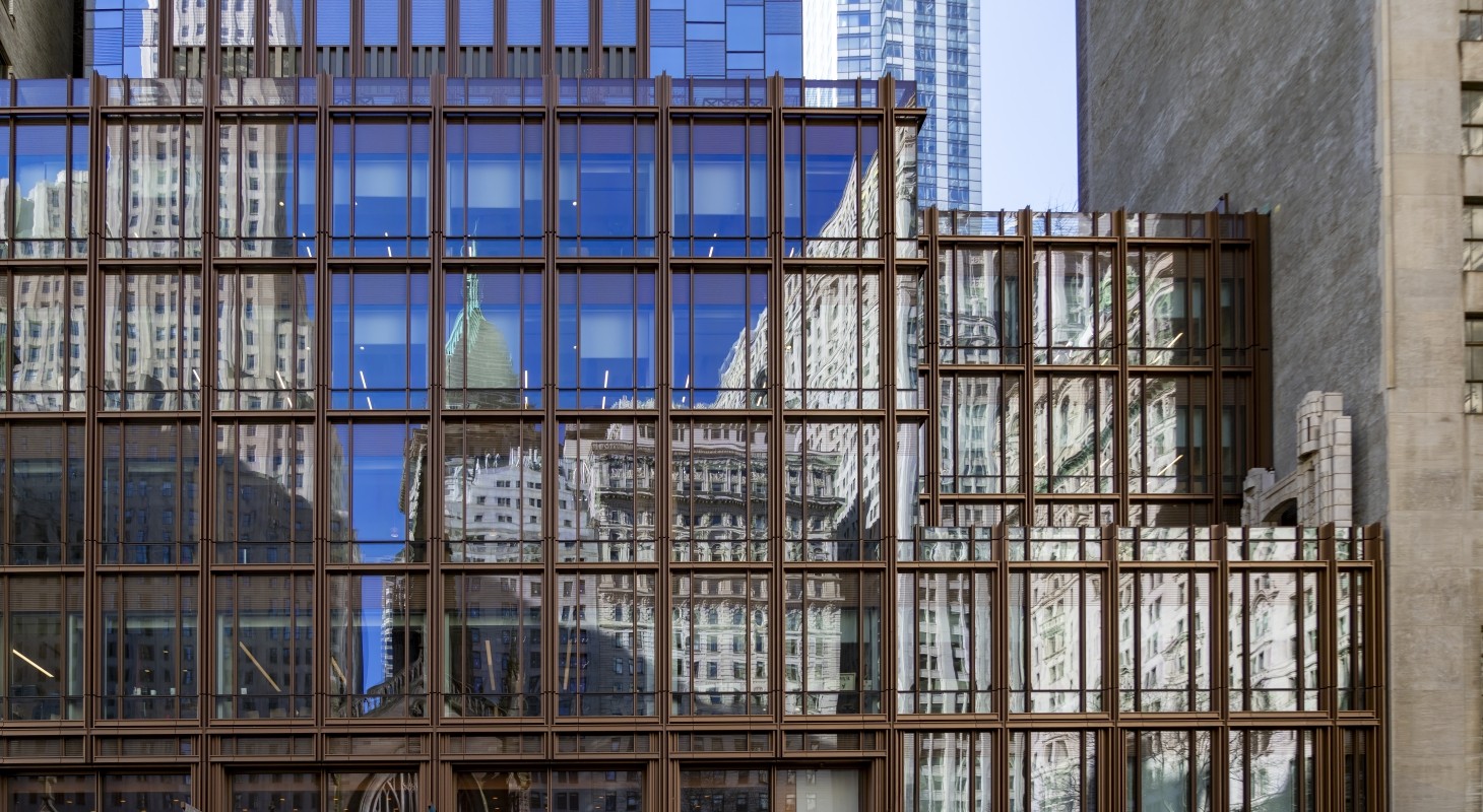 buildings in lower manhattan reflected in windows