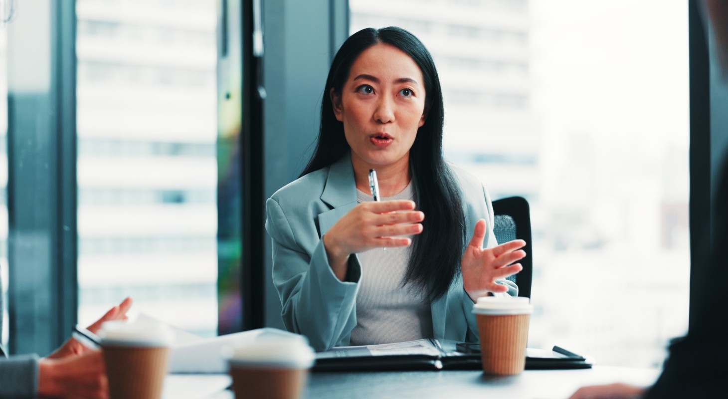 female board director engaged in conversation in conference room