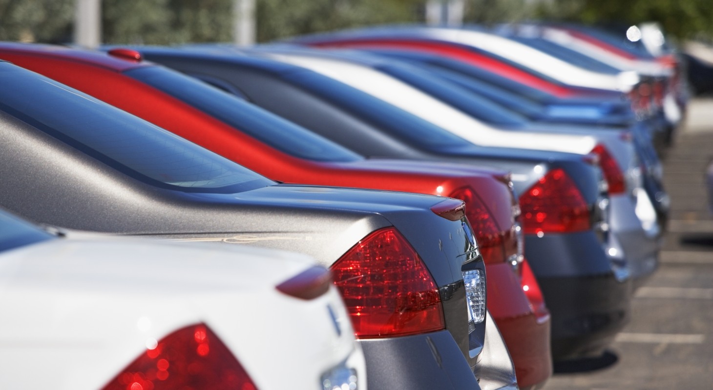 closeup of red white and blue cars on a lot