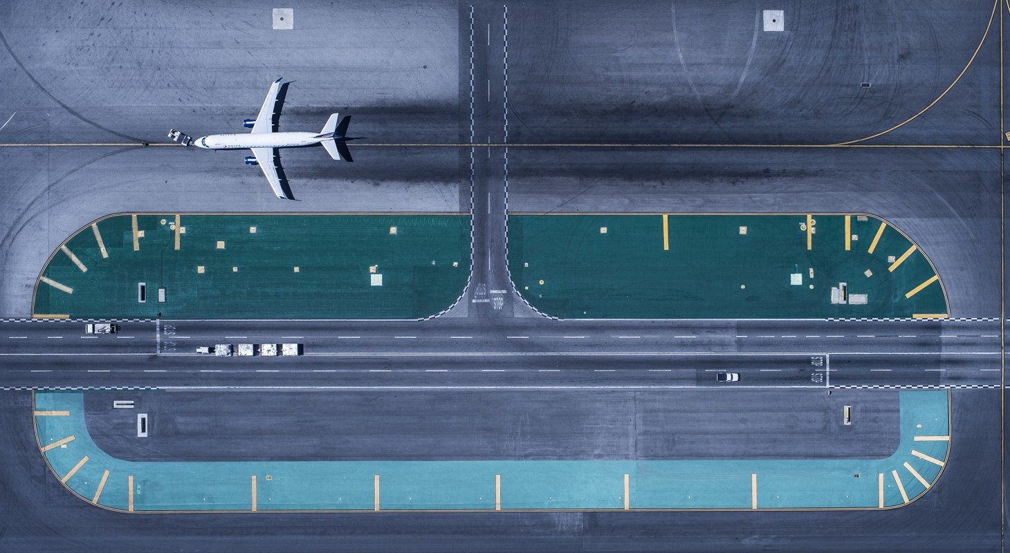 overhead view of runway at lax airport with one airplane