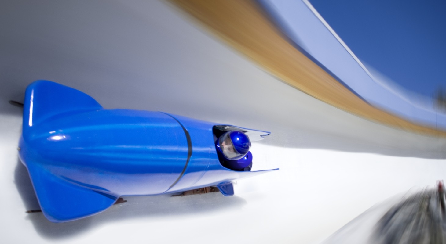 bright blue two person bobsled racing on icy track