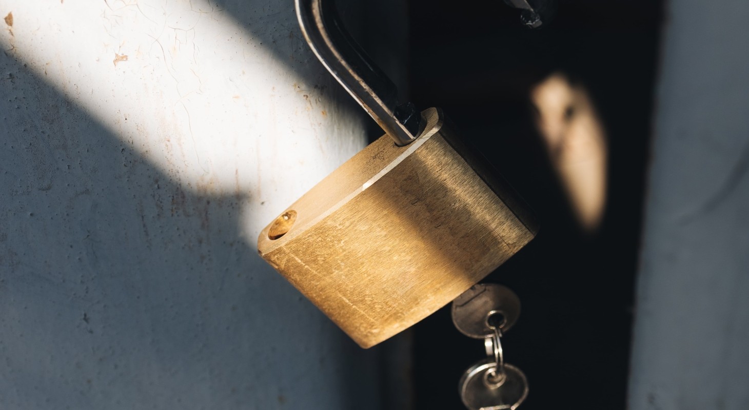 medal padlock with two keys on old garage door