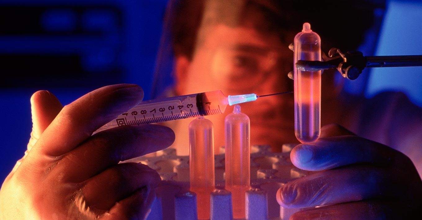 image of a man filling a test tube