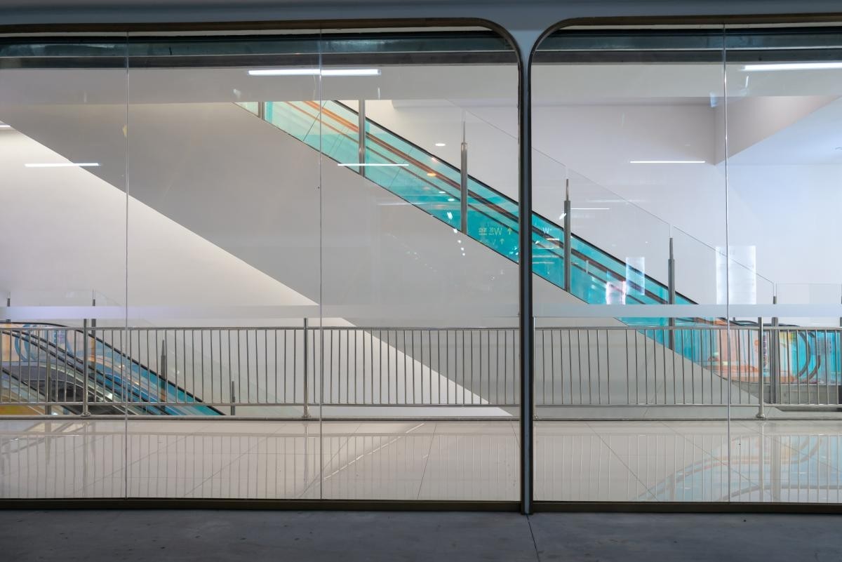 escalators framed with blue glass