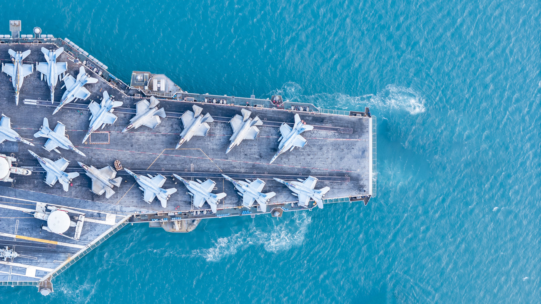 military navy ship carrying fighter jets