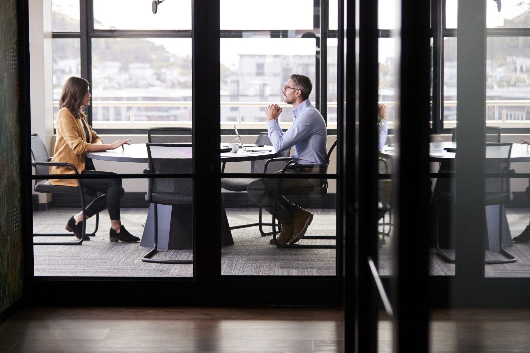 executives seated at conference table talking