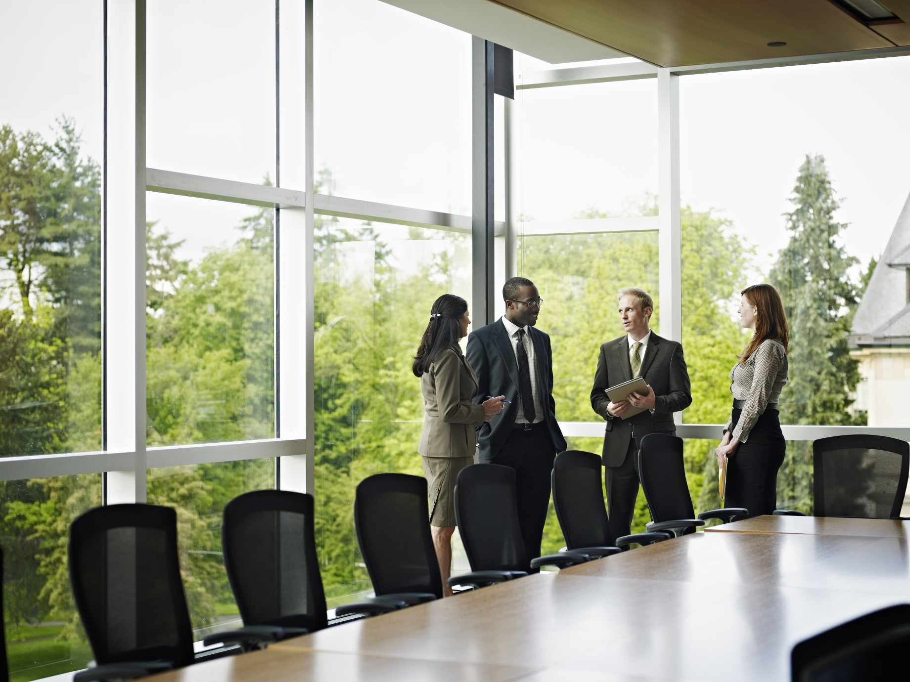coworkers standing in conference room
