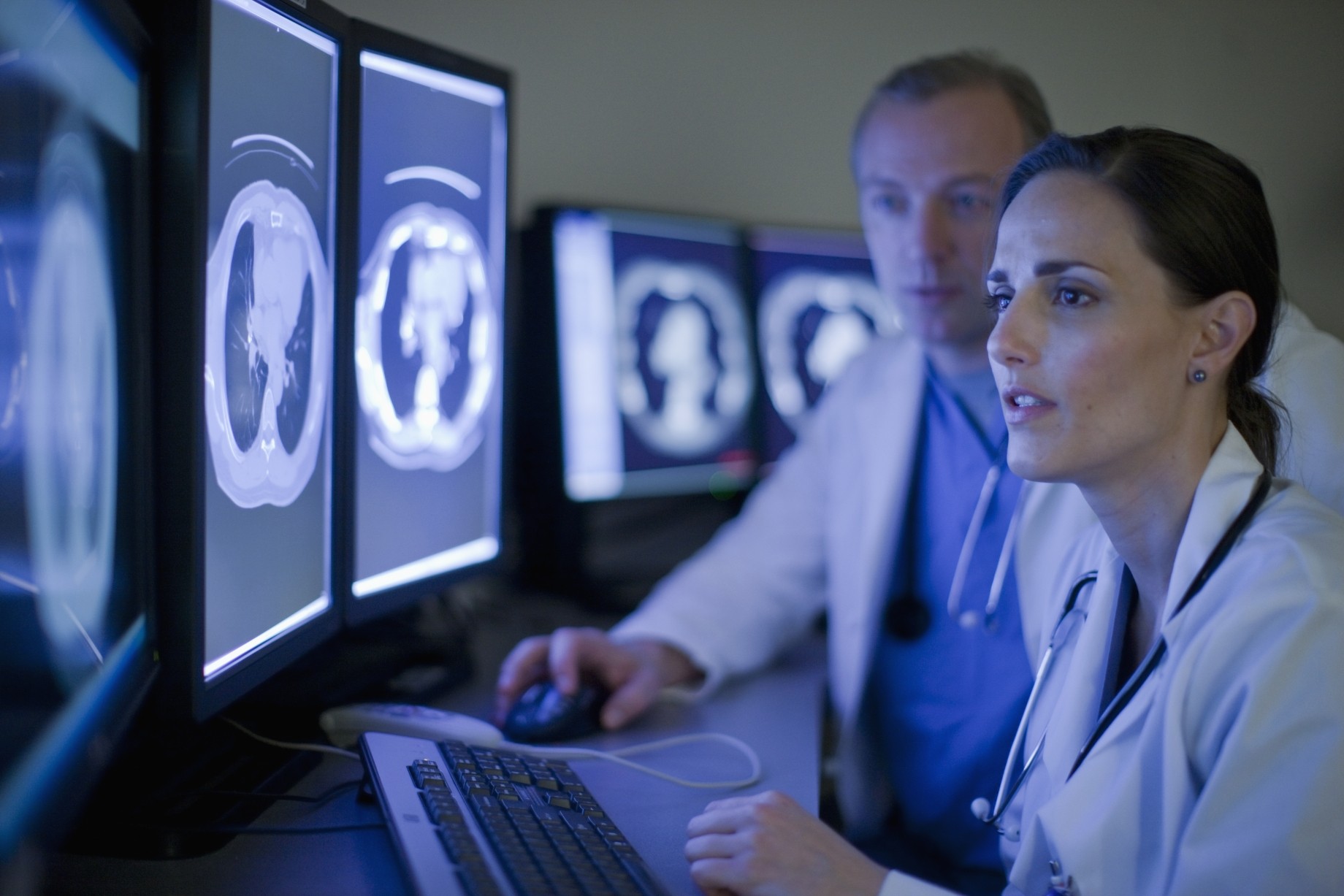 doctors look at mri images on computer screens