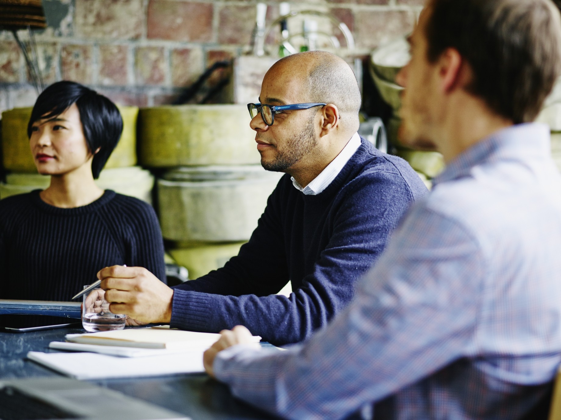 two men and one woman meeting in a startup office