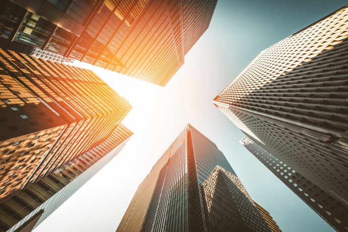 skyscrapers reaching towards sunlit sky
