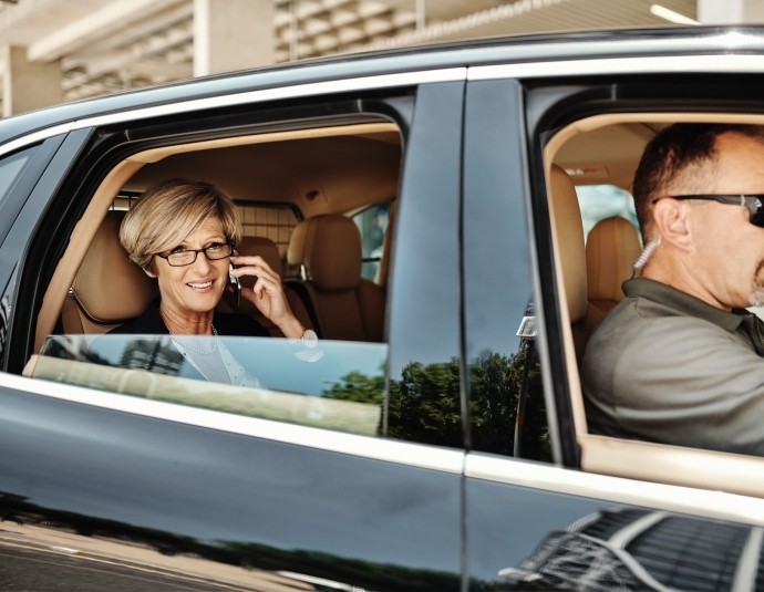 business woman with security guard driving