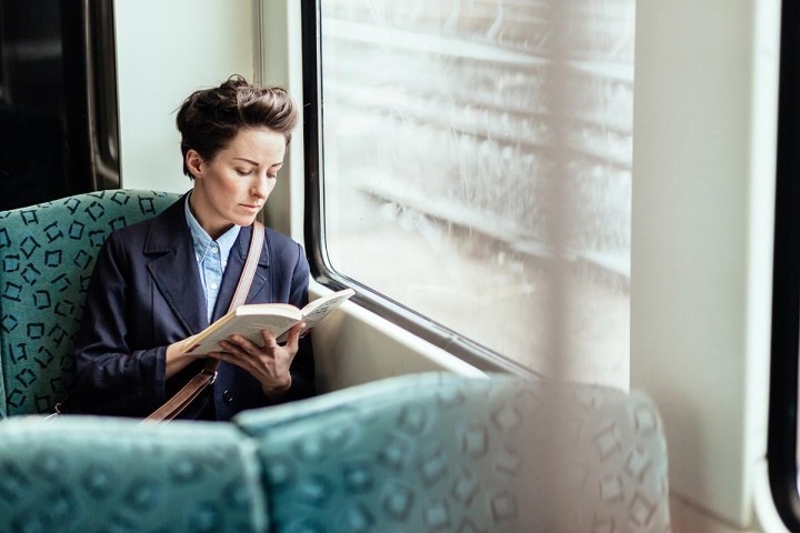 woman on train reading book