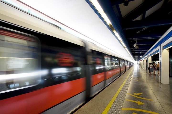 blurred view of speeding red train in station