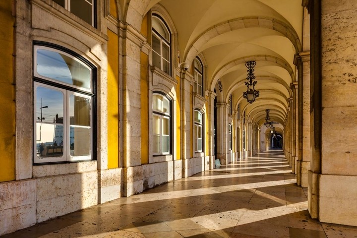 long breezeway of arches in golden light