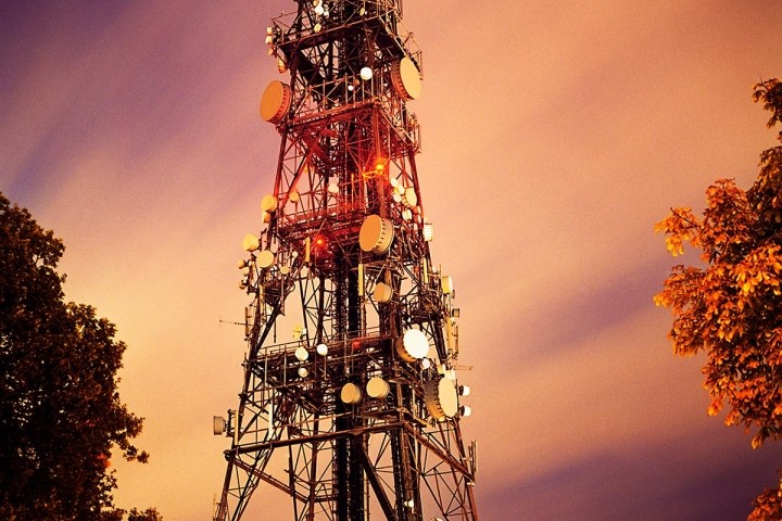 massive radio transmitter tower against sunset