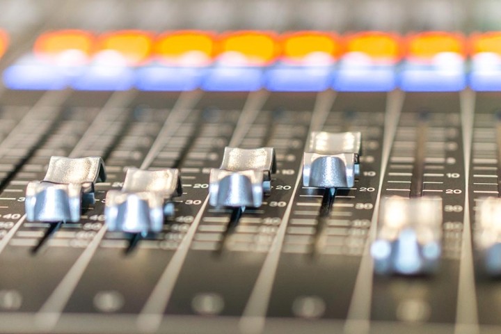 sound mixing board with orange and blue lights