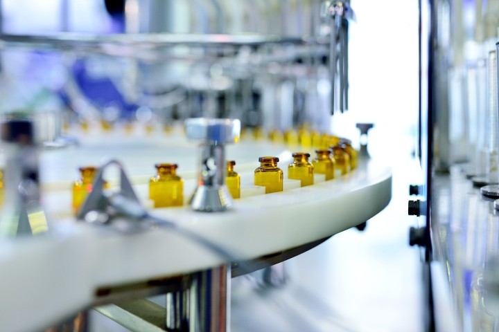 close up of brown glass bottle production line